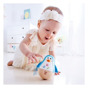 Baby playing with penguin musical wobbler