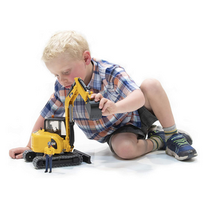 Child playing with Cat Mini Excavator with Worker